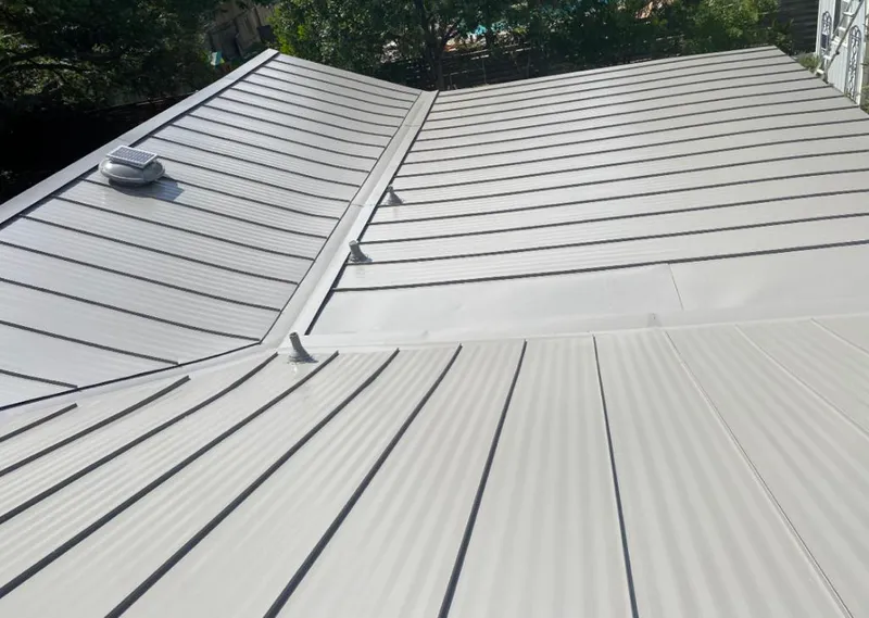 Solar attic fan installed on a metal roof for Roof Ventilation in Greenville